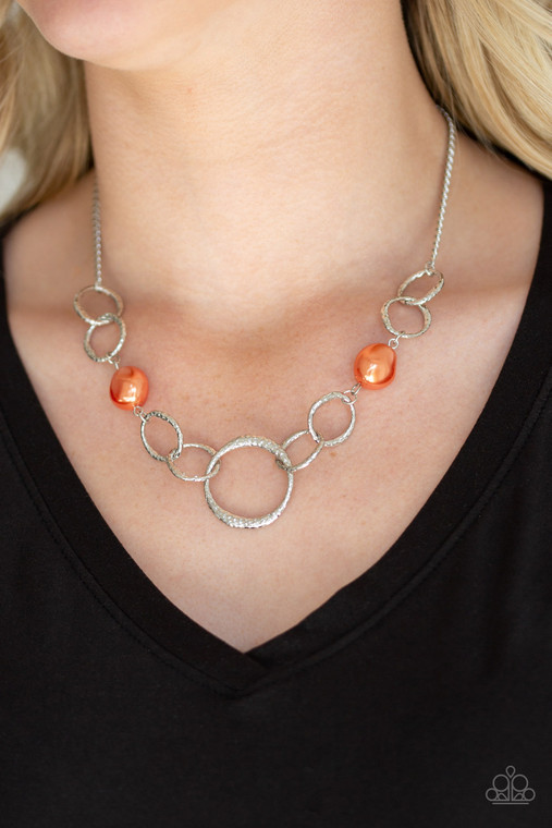 Pearly orange pebbles join with delicately hammered silver rings below the collar for a refined flair. Features an adjustable clasp closure.

Sold as one individual necklace. Includes one pair of matching earrings.