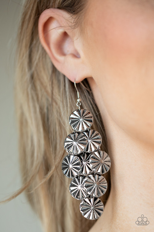 Creased in star-like patterns, antiqued silver discs attach to a silver netted backdrop, linking into an edgy lure. Earring attaches to a standard fishhook fitting.

Sold as one pair of earrings.