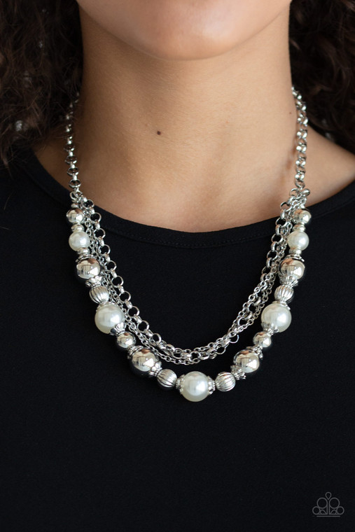 Layers of mismatched silver chains give way to a strand of ornate silver beads and oversized white pearls that cascade below the collar for a refined flair. Features an adjustable clasp closure.

Sold as one individual necklace. Includes one pair of matching earrings.