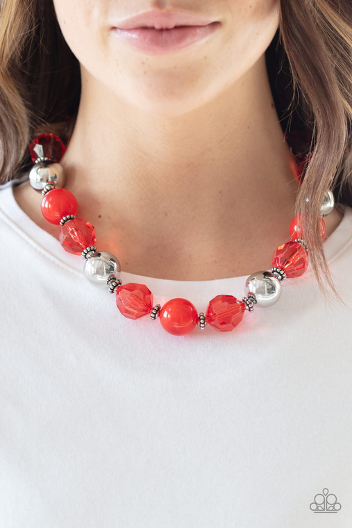 Infused with dainty silver accents, exaggerated display of oversized silver beads, faceted red crystal-like beads, and cloudy red beads are threaded along an invisible wire below the collar for a colorfully statement-making fashion. Features an adjustable clasp closure.

Sold as one individual necklace. Includes one pair of matching earrings.