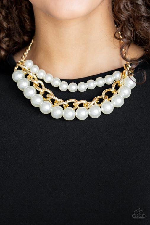 Two strands of dramatic white pearls flank one strand of oversized gold chain, creating statement-making layers below the collar. Features an adjustable clasp closure.

Sold as one individual necklace. Includes one pair of matching earrings.
