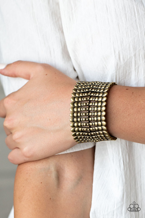 Infused with dainty brass beads, rippling brass bars are threaded along stretchy bands around the wrist, creating a rustic centerpiece.

Sold as one individual bracelet.