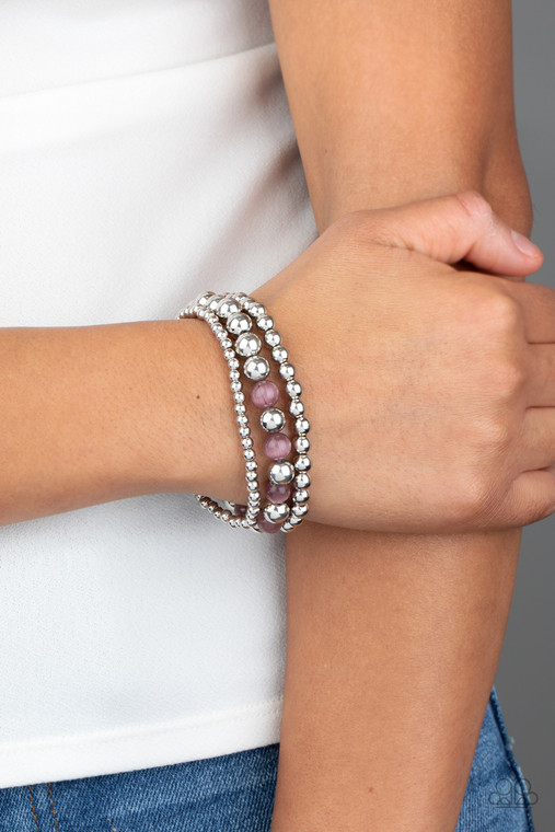Infused with glowing purple moonstones, shiny silver beads are threaded along stretchy bands for a whimsical look.

Sold as one individual bracelet.