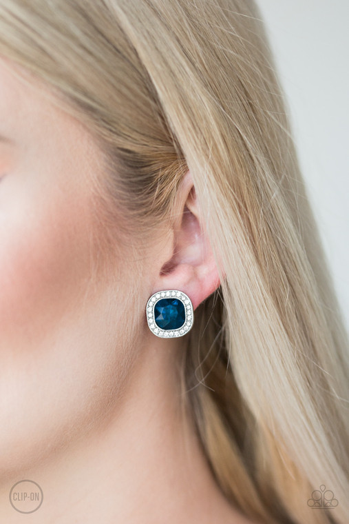 A regal blue gem is pressed into the center of a shimmery silver frame radiating with glassy white rhinestones for a glamorous look. Earring attaches to a standard clip-on fitting.

Sold as one pair of clip-on earrings.