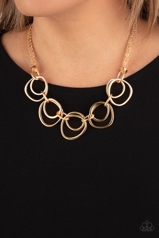 Infused with decorative gold links, an asymmetrical assortment of gold rings delicately link below the collar for a refined flair. Features an adjustable clasp closure.

Sold as one individual necklace. Includes one pair of matching earrings.