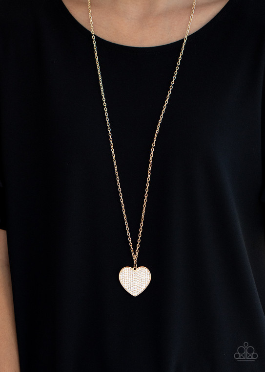 Encrusted in row after row of glassy white rhinestones, a dazzling gold heart swings from the bottom of a lengthened gold chain for a charming finish. Features an adjustable clasp closure.

Sold as one individual necklace. Includes one pair of matching earrings.