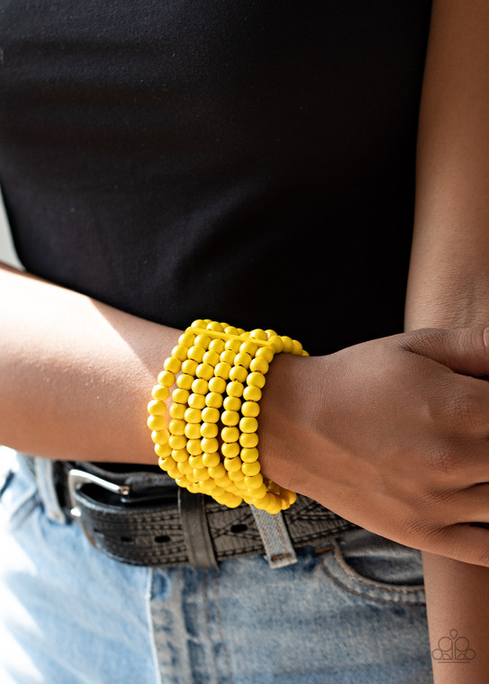 Held in place with rectangular wooden fittings, a collection of sunny yellow wooden beads are threaded along stretchy bands around the wrist, creating colorful layers.

Sold as one individual bracelet.