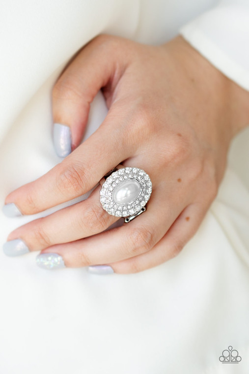 Two rings of glassy white rhinestones spin around a pearly white center for a refined flair. Features a stretchy band for a flexible fit.

Sold as one individual ring.