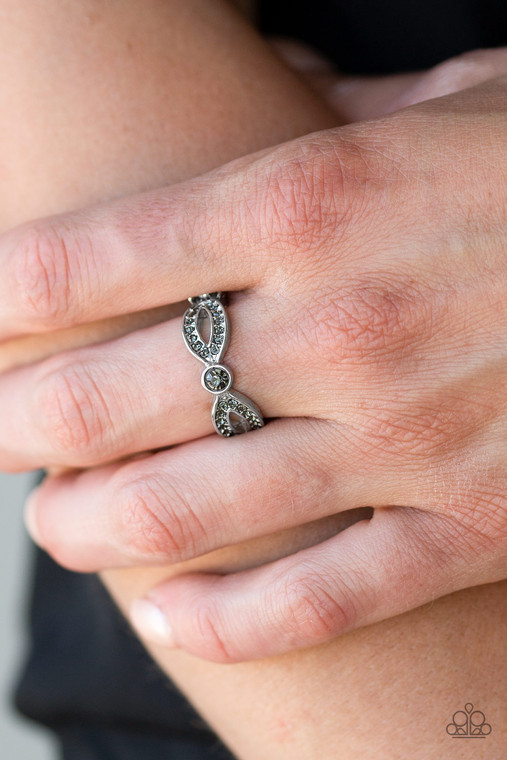 Encrusted in smoky rhinestones, glistening silver ribbons loop away from a dazzling rhinestone center for a refined look. Features a dainty stretchy band for a flexible fit.

Sold as one individual ring.