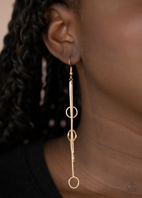 Gradually increasing in length, dainty gold rings dangle from the bottoms of sleek gold chains, creating an elegant tassel. Earring attaches to a standard fishhook fitting.

Sold as one pair of earrings.