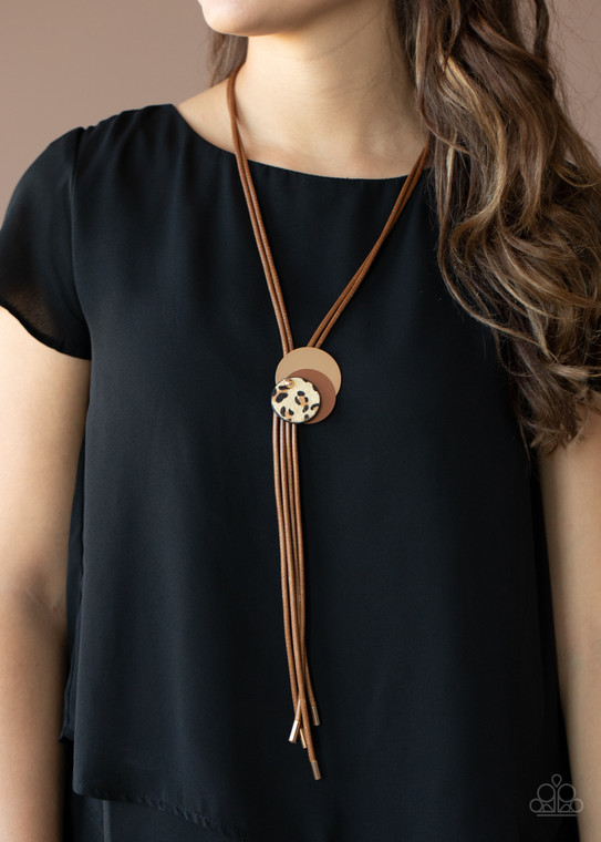 Strands of brown leather are connected by series of contracting circles ending with a leopard print circle and dangling leather strands. November 2020 Life of the Part Exclusive.

Sold as one individual necklace. Includes one pair of matching earrings.