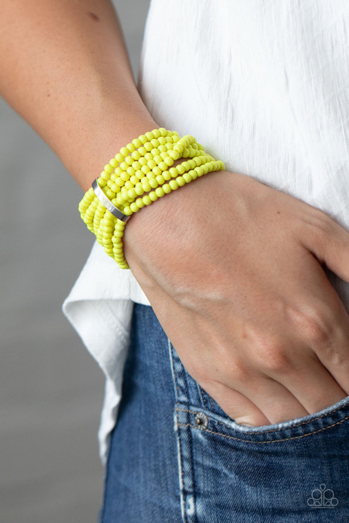 Held together by a dainty silver fitting, a vibrant collection of Green Sheen beads are threaded along stretchy bands around the wrist, creating colorful layers.

Sold as one individual bracelet.