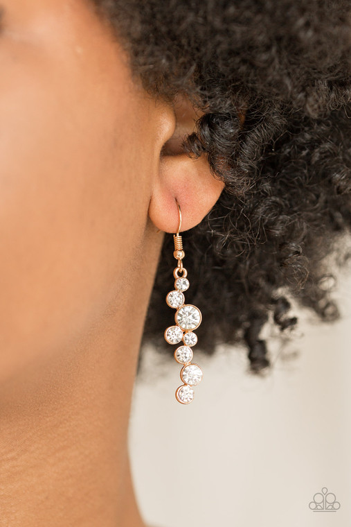 Varying in size, glittery white rhinestones tumble from the ear, coalescing into a magnificent lure. Earring attaches to a standard fishhook fitting.

Sold as one pair of earrings.
