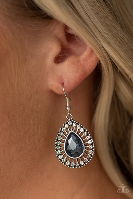 A teardrop blue rhinestone is pressed into an ornate silver teardrop frame radiating with dainty white rhinestones for a refined flair. Earring attaches to a standard fishhook fitting.

Sold as one pair of earrings.