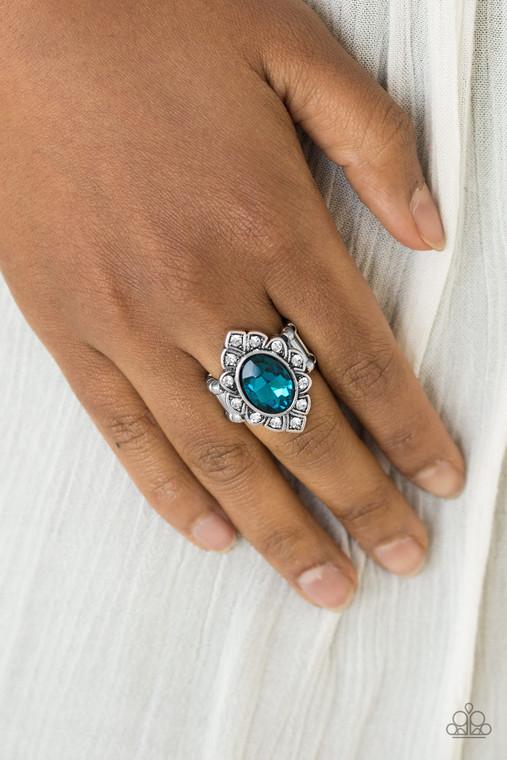 A glassy blue gem is pressed into a marquise-shaped silver frame radiating with glittery white rhinestones for a regal look. Features a stretchy band for a flexible fit.

Sold as one individual ring.