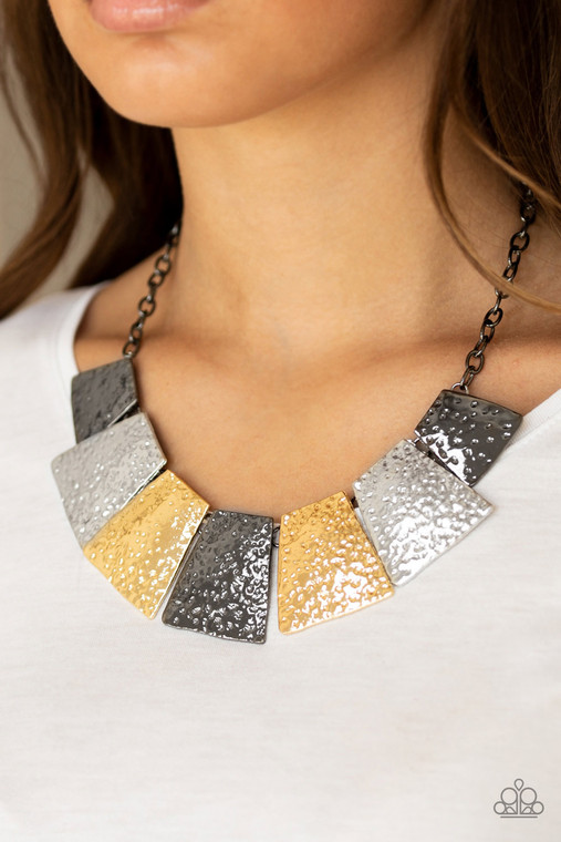 Featuring flared edges, delicately hammered gunmetal, silver, and gold plates link below the collar for a fierce look. Features an adjustable clasp closure.

Sold as one individual necklace. Includes one pair of matching earrings.