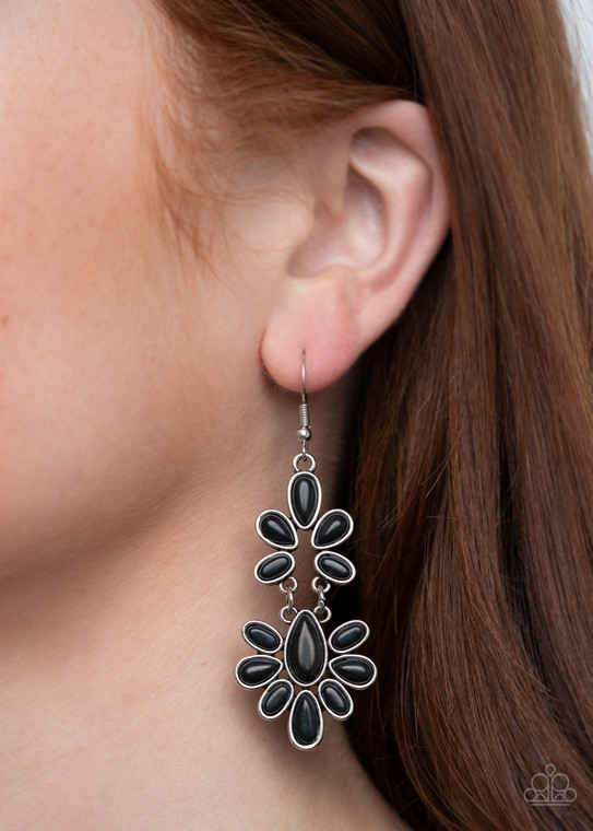 Encased in sleek silver frames, earthy black stone teardrop frames delicately link into a wildly wonderfully floral pattern. Earring attaches to a standard fishhook fitting.

Sold as one pair of earrings.