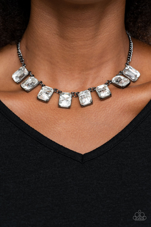 Encased in sleek gunmetal fittings, a regal chain of oversized white emerald style gems link below the collar for a timeless finish. Features an adjustable clasp closure.

Sold as one individual necklace. Includes one pair of matching earrings.