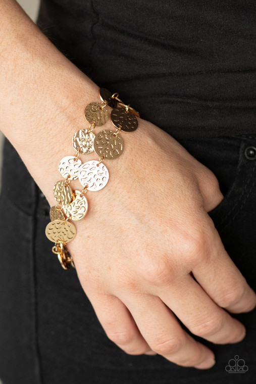 Two rows of hammered gold or silver discs wrap around the wrist, creating an edgy shimmer. Features an adjustable clasp closure.

Sold as one individual bracelet.