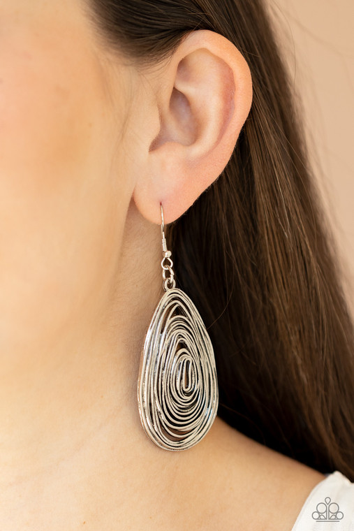 Brushed in an antiqued shimmer, rustic silver wire delicately coils into an asymmetrical teardrop frame for a handcrafted look. Earring attaches to a standard fishhook fitting.

Sold as one pair of earrings.