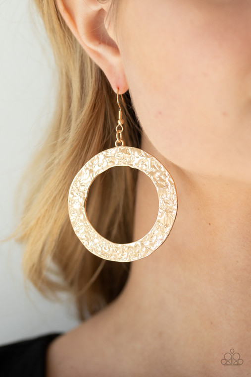 A flat gold circular frame has been hammered in blinding detail for a handcrafted look. Earring attaches to a standard fishhook fitting.

Sold as one pair of earrings.