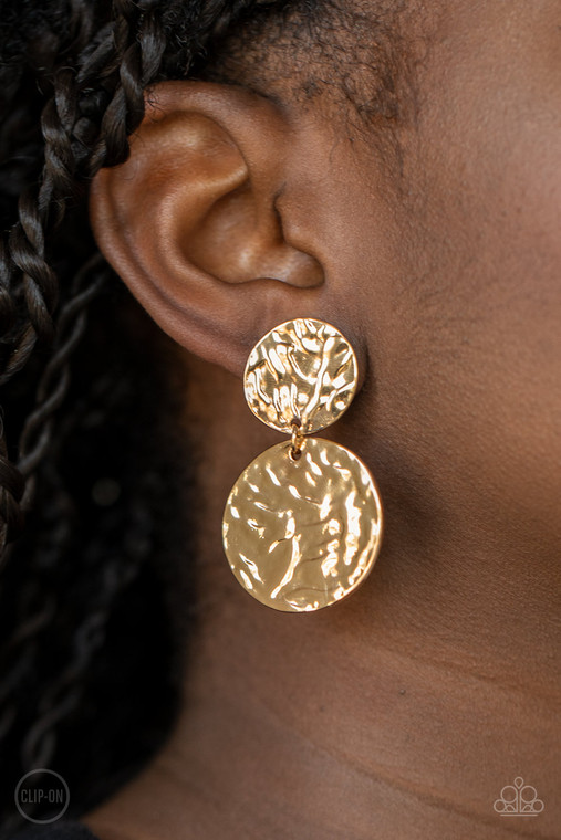Varying in size, hammered gold discs link into a rippling lure. Earring attaches to a standard clip-on fitting.

Sold as one pair of clip-on earrings.