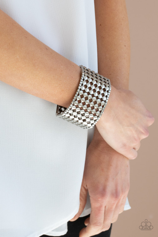 Bordered by rows of silver cubes, stacked rows of antiqued silver dots connect into rectangular frames that are threaded along stretchy bands around the wrist for an edgy geometric finish.

Sold as one individual bracelet.