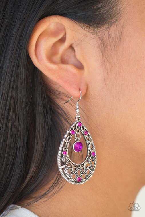 Glistening and studded silver filigree swirls along a shimmery silver frame radiating with glittery pink rhinestones. A sparkling pink rhinestone swings from the top of the frame for a refined finish. Earring attaches to a standard fishhook fitting.

Sold as one pair of earrings.