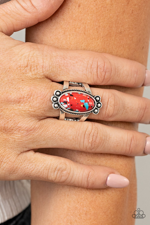 Featuring a faux marble finish, an elongated oval speckled red stone is pressed into the center of a textured silver frame dotted with antiqued silver studs, creating a tranquil centerpiece atop the finger. Features a stretchy band for a flexible fit.

Sold as one individual ring.