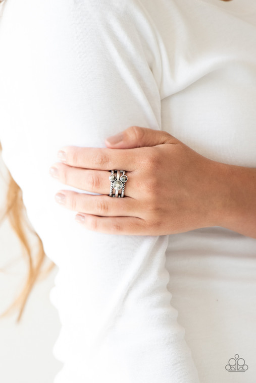 A trio of glittery hematite rhinestones are sprinkled along smooth and twisted silver bands, creating edgy layers across the finger. Features a stretchy band for a flexible fit.

Sold as one individual ring.