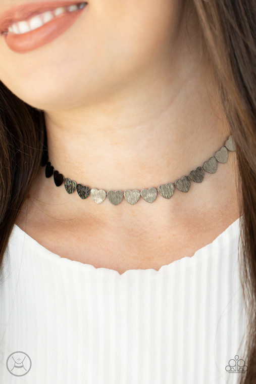 Featuring a shimmery scratch finish, a dainty collection of shiny gunmetal heart frames connect around the neck for a flirtatious look. Feature an adjustable clasp closure.

Sold as one individual choker necklace. Includes one pair of matching earrings.
