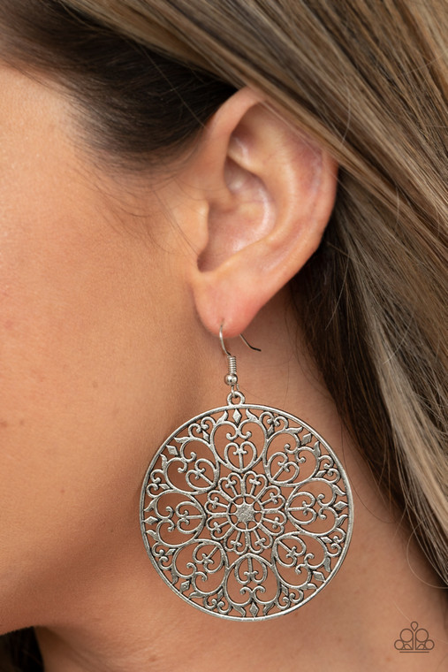 Decorative silver filigree fills the center of a silver hoop, creating a whimsical mandala pattern. Earring attaches to a standard fishhook fitting.

Sold as one pair of earrings.