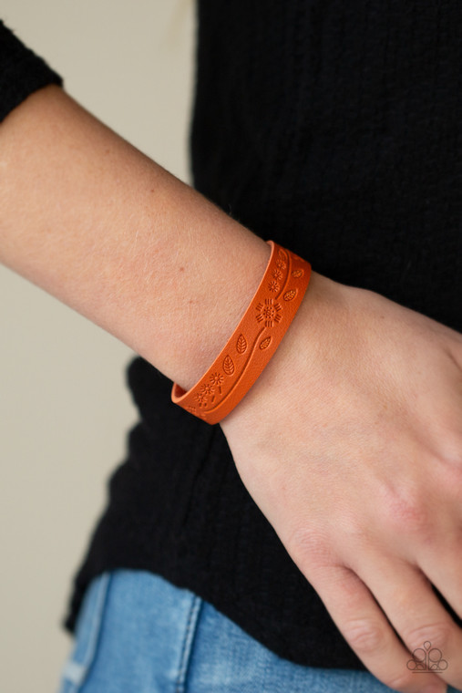 Stamped in a leafy southwestern inspired pattern, a rustic orange leather band wraps around the wrist for a colorfully seasonal look. Features an adjustable snap closure.

Sold as one individual bracelet.