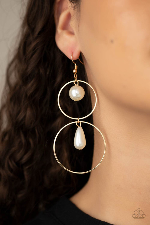 A classic white pearl swings from the top of a shiny gold hoop that is linked to another gold hoop by a pearly teardrop bead, creating a stunningly stacked display. Earring attaches to a standard fishhook fitting.

Sold as one pair of earrings.