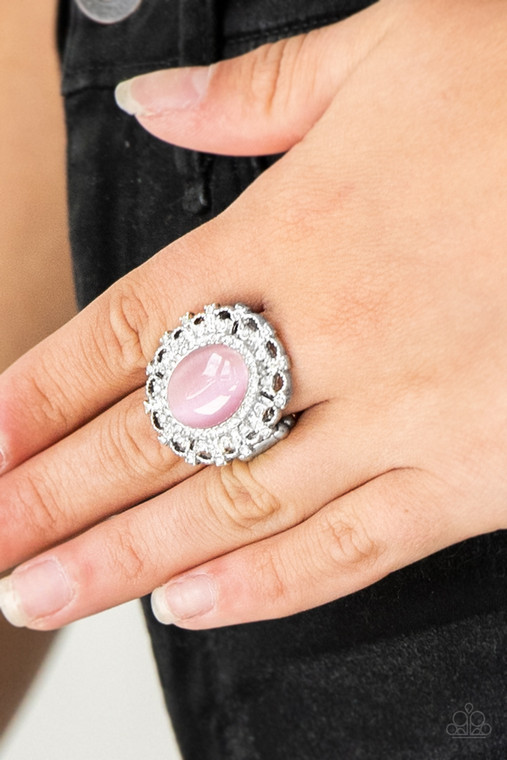 Encrusted in dainty white rhinestones, a frilly silver frame spins around a glowing pink moonstone center for a regal look. Features a stretchy band for a flexible fit.

Sold as one individual ring.