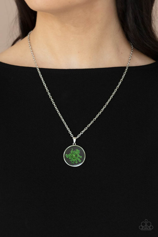 A dainty green firework-like flower is encased inside a glassy frame, creating a whimsical pendant below the collar. Features an adjustable clasp closure.

Sold as one individual necklace. Includes one pair of matching earrings.