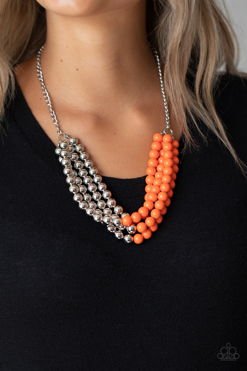 Featuring half silver and half orange beads, a colorful collision of beads layer below the collar for a powerful pop of color. Features an adjustable clasp closure.

Sold as one individual necklace. Includes one pair of matching earrings.