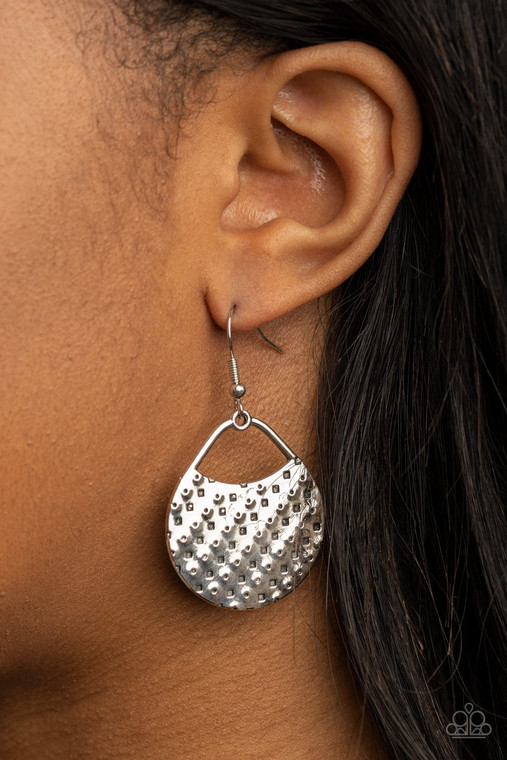 The front of a uniquely shaped silver frame is stamped and hammered in slanting rows of square and dotted patterns for a one-of-a-kind look. Earring attaches to a standard fishhook fitting.

Sold as one pair of earrings.