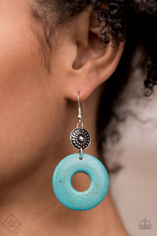 A large turquoise ring dangles from an antiqued silver disc, accented with raised dots in concentric circles. The timeless combination of turquoise and silver and the intricate textures bring an undeniably artisan feel to the piece. Earring attaches to a standard fishhook fitting.

Sold as one pair of earrings.