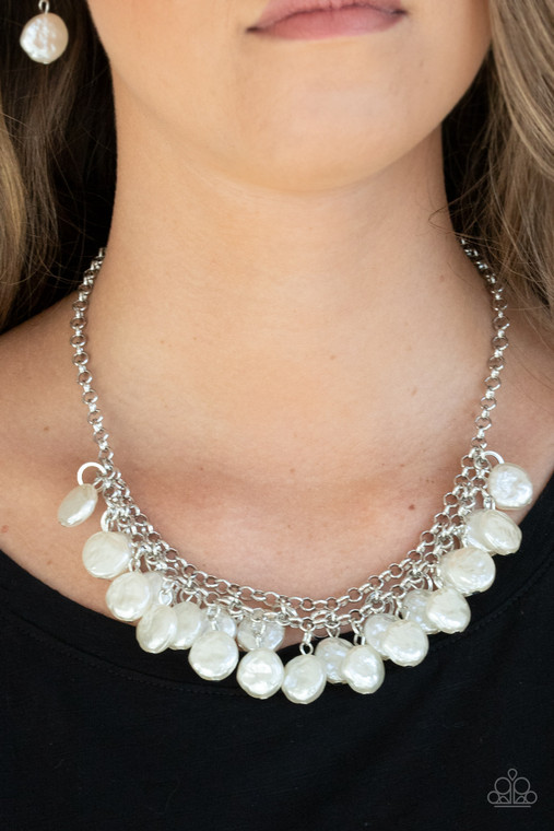 Featuring delicately hammered surfaces, rows of pearly white beads cascade from the bottoms of interlocking silver chains. Dainty silver rings swing from the top of the timelessly tiered display, creating a refined fringe below the collar. Features an adjustable clasp closure.

Sold as one individual necklace. Includes one pair of matching earrings.
