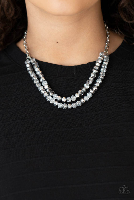 A sturdy silver chain connects double strands of silver and clear beads. The mirrored multi-faceted beads connect below the collar for a fiercely stunning style. Features an adjustable clasp closure.

Sold as one individual necklace. Includes one pair of matching earrings.