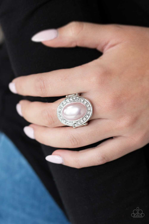 A pearly pink bead is pressed into a silver oval frame radiating with a ring of glittery white rhinestones, creating a regal statement piece atop the finger. Features a stretchy band for a flexible fit.

Sold as one individual ring.