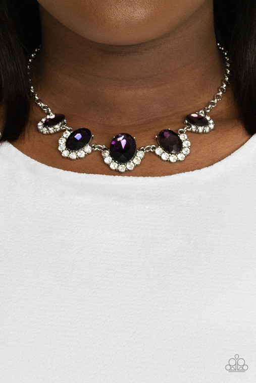 Gradually increasing in size at the center, the sparkly bottoms of oversized purple gems are bordered in rows of glassy white rhinestones as they link below the collar for a dramatic effect. Features an adjustable clasp closure.

Sold as one individual necklace. Includes one pair of matching earrings.