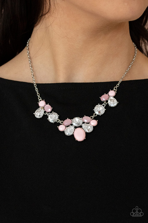 Varying in opacity and shape, mismatched pink beads attach to oversized white rhinestones, creating bubbly frames that delicately link into an ethereal display below the collar. Features an adjustable clasp closure.

Sold as one individual necklace. Includes one pair of matching earrings.
