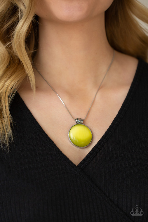 Attached to a decorative silver fitting, a dramatically oversized Illuminating cat's eye stone pendant glides along a rounded silver snake chain below the collar for a powerful pop of color. Features an adjustable clasp closure.

Sold as one individual necklace. Includes one pair of matching earrings.