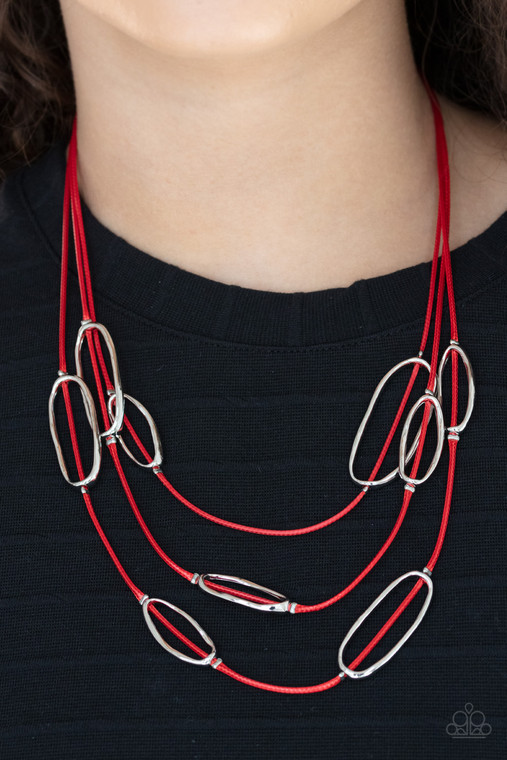 An asymmetrical collection of hammered silver ovals are fitted in place along three rows of shiny red cords, creating an edgy display below the collar. Features an adjustable clasp closure.

Sold as one individual necklace. Includes one pair of matching earrings.