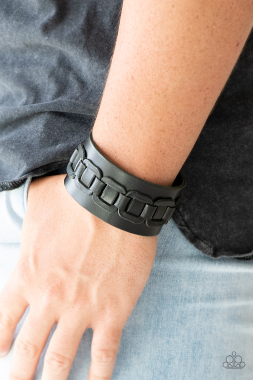 Featuring leather tread-like patterns, a thick black leather band wraps around the wrist for a rugged look. Features an adjustable snap closure.

Sold as one individual bracelet.