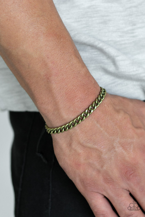 Shiny black cording knots around the ends of a brass beveled cable chain that is wrapped across the top of the wrist for a versatile look. Features an adjustable sliding knot closure.

Sold as one individual bracelet.