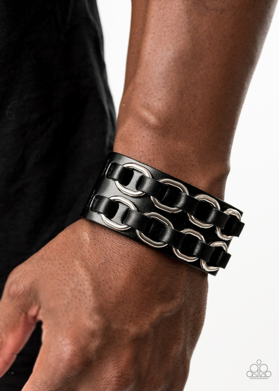 Black leather laces thread through two rows of bold silver links across the front of a thick black leather band for a gritty look. Features an adjustable snap closure.

Sold as one individual bracelet.