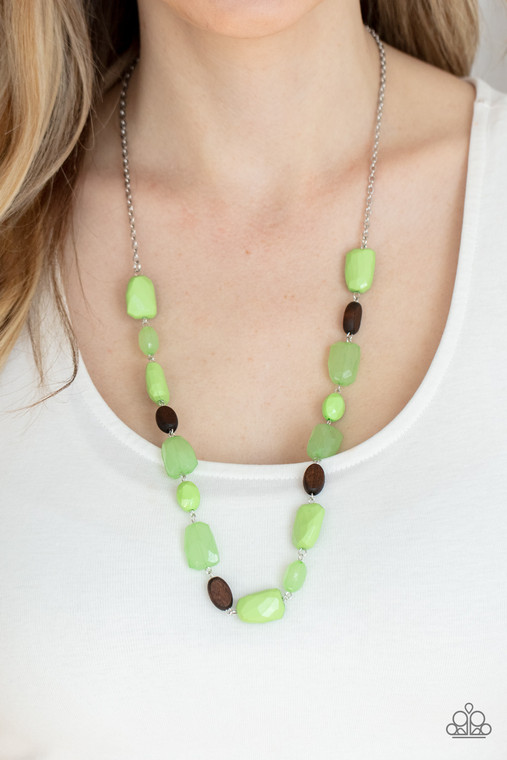 Varying in opacity, a mixed assortment of faceted Apple Green beads delicately link with dainty wooden beads across the chest, creating a whimsically earthy display. Features an adjustable clasp closure.

Sold as one individual necklace. Includes one pair of matching earrings.